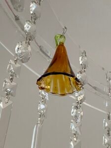 Bespoke luxury ceiling fixture combining hand-cut crystal drops with custom LED and warm neon illumination.
