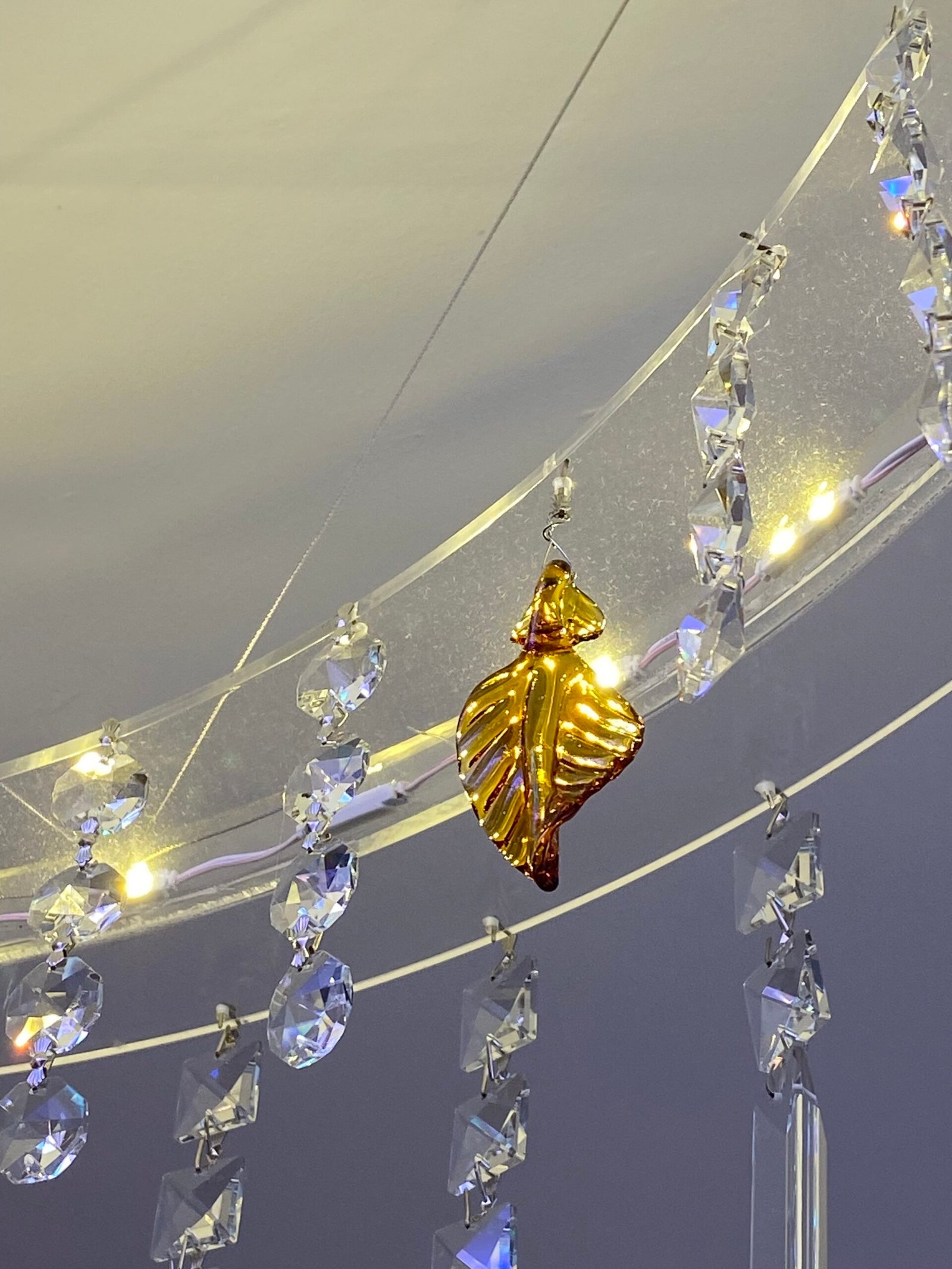 Close-up detail of handmade crystal elements and glowing neon lighting